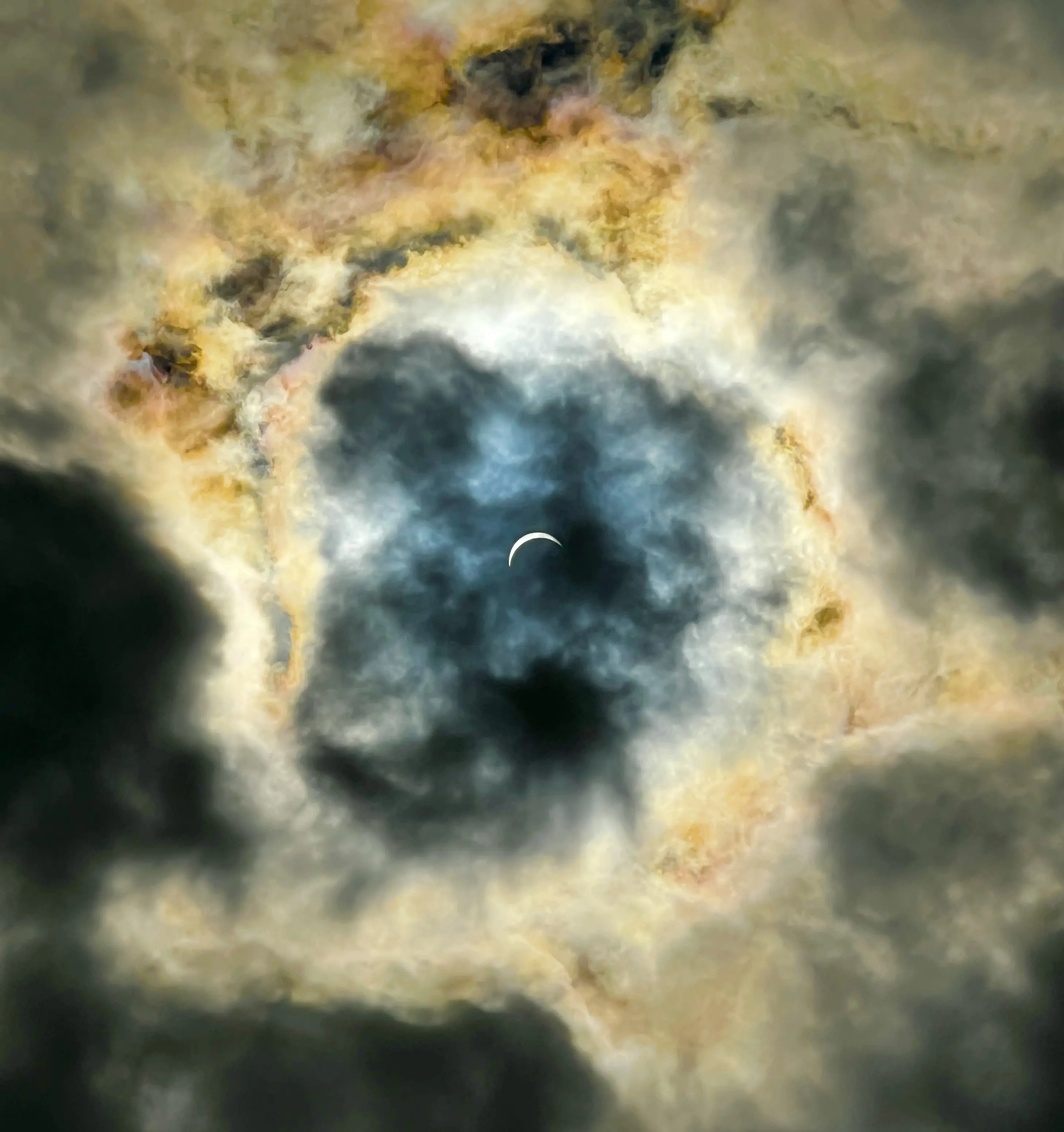 A solar eclispe in the middle of some clouds